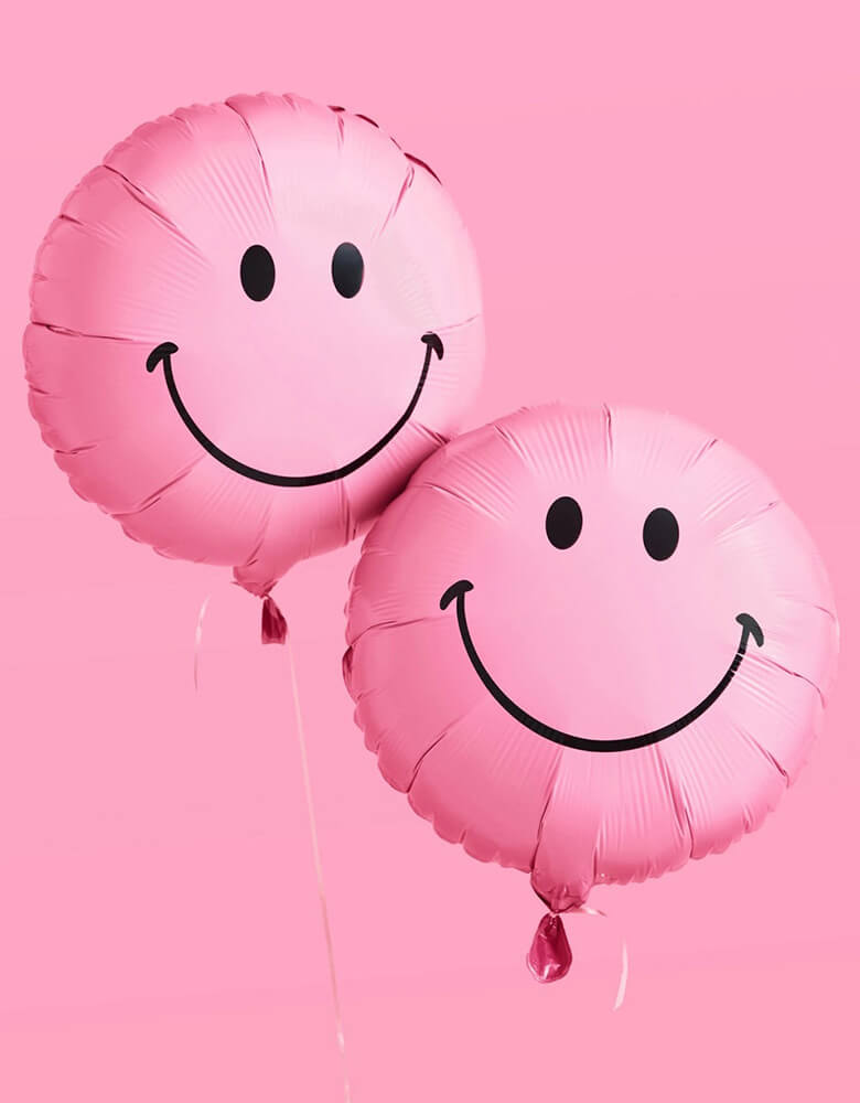 Momo Party's 18" pink smiley foil balloons by Xo, Fetti. Comes in a set of 2, these happy balloons make for the perfect accessory to your celebration. Smile big with these matte happy face foil balloons and keep the whole party happy all night long.