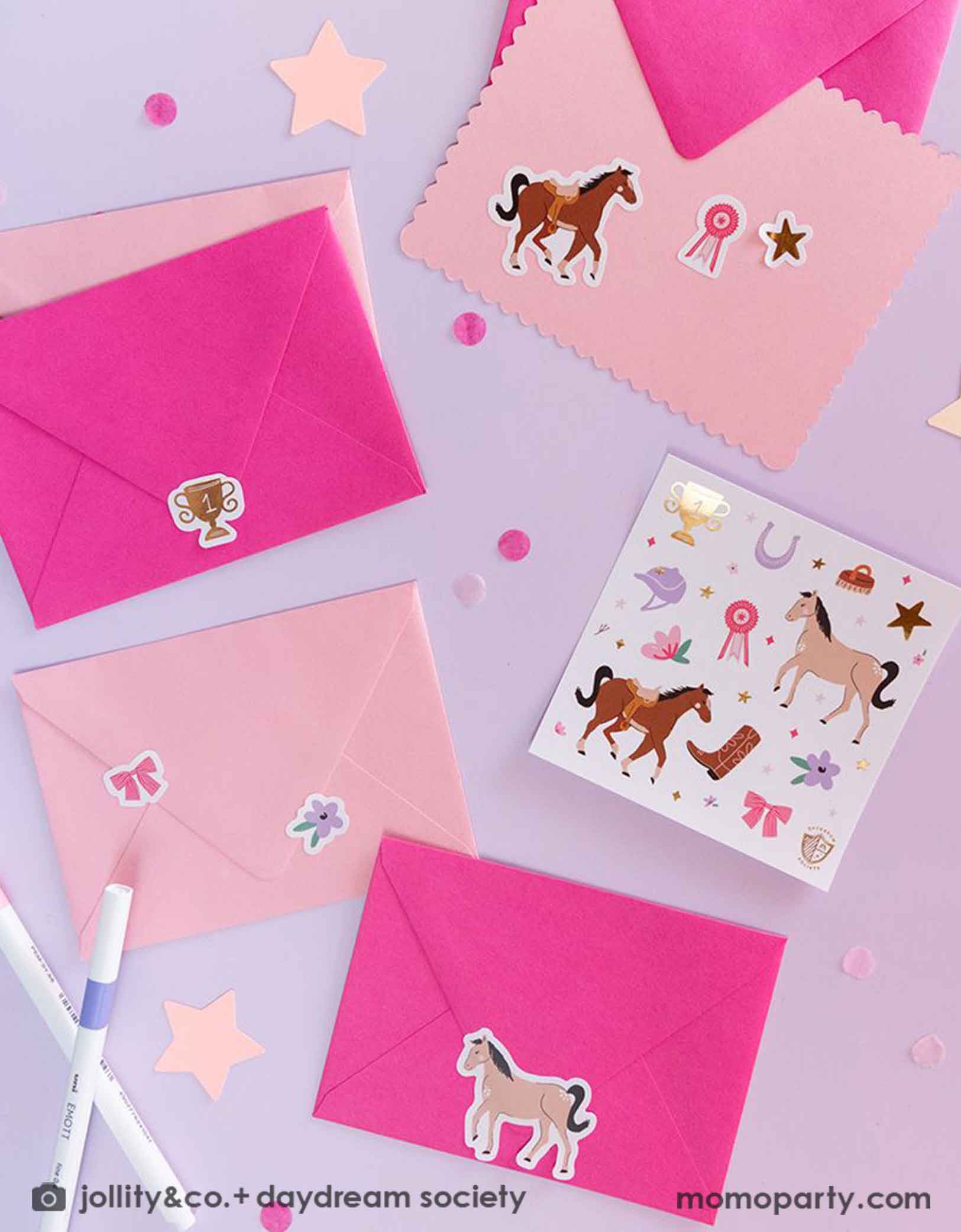 A few pink envelopes decorated with Momo Party's Pony Tales Sticker Set by Daydream Society. This sticker set comes in a set of 4 sheets, including images of horses, ribbons, florals and bows! They make the perfect birthday invitations or gift for every pony lover. Around the envelopes are some pink confetti, some star shaped paper decorations and pens.