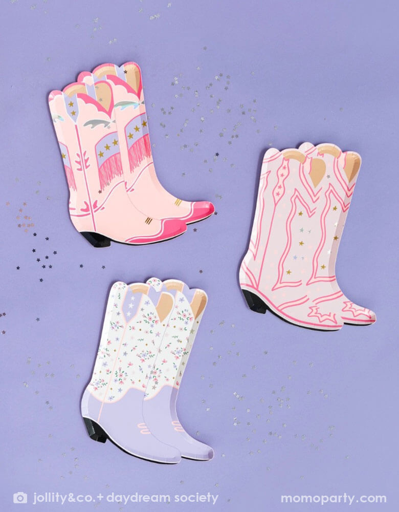 An overhead shot of Momo Party's 8" x 6" Pony Tales Large Boot Shaped Plates by Daydream Society on a purple background and confetti around. Comes in a set of 8 cowgirl boots shaped plates in 4 different designs and colors, these plates feature pink and purple boots trimmed with gold and silver foil details are perfect for a Western cowgirl themed party or girl's horse/pony themed birthday celebration.