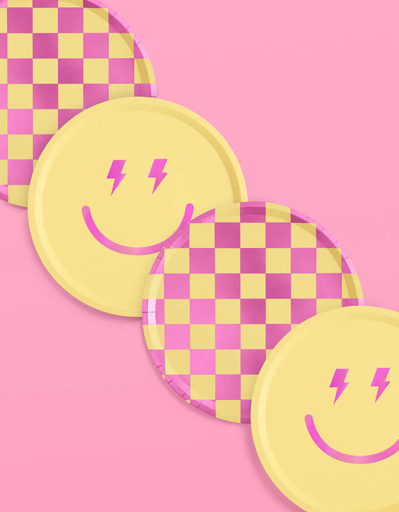 Momo Party's 9" Preppy Party Plates by Xo, fetti. Comes as 24 paper plates a set in two different colors/designs including yellow and pink checkers and a smiely face with lighting bolt eyes in pink, these groovy paper plates are perfect for a happy celebration.