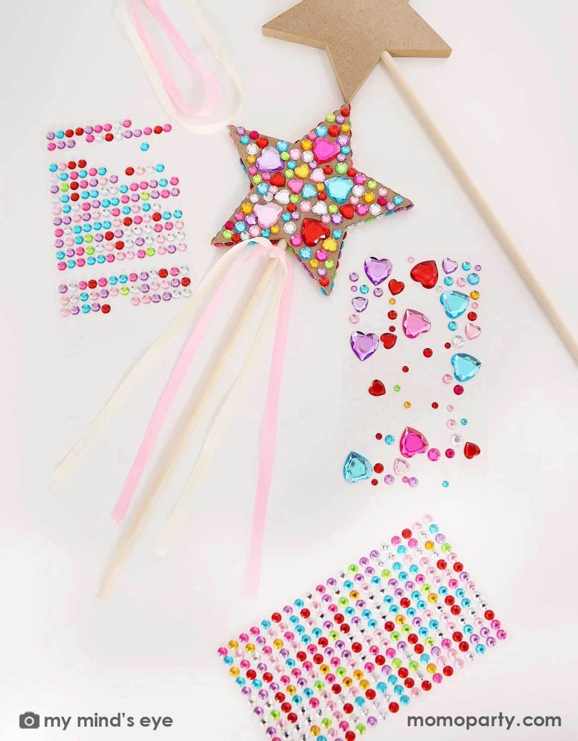 Momo Party's princess star-shaped wooden wand covered with colorful gemstone stickers and beads against a white background.