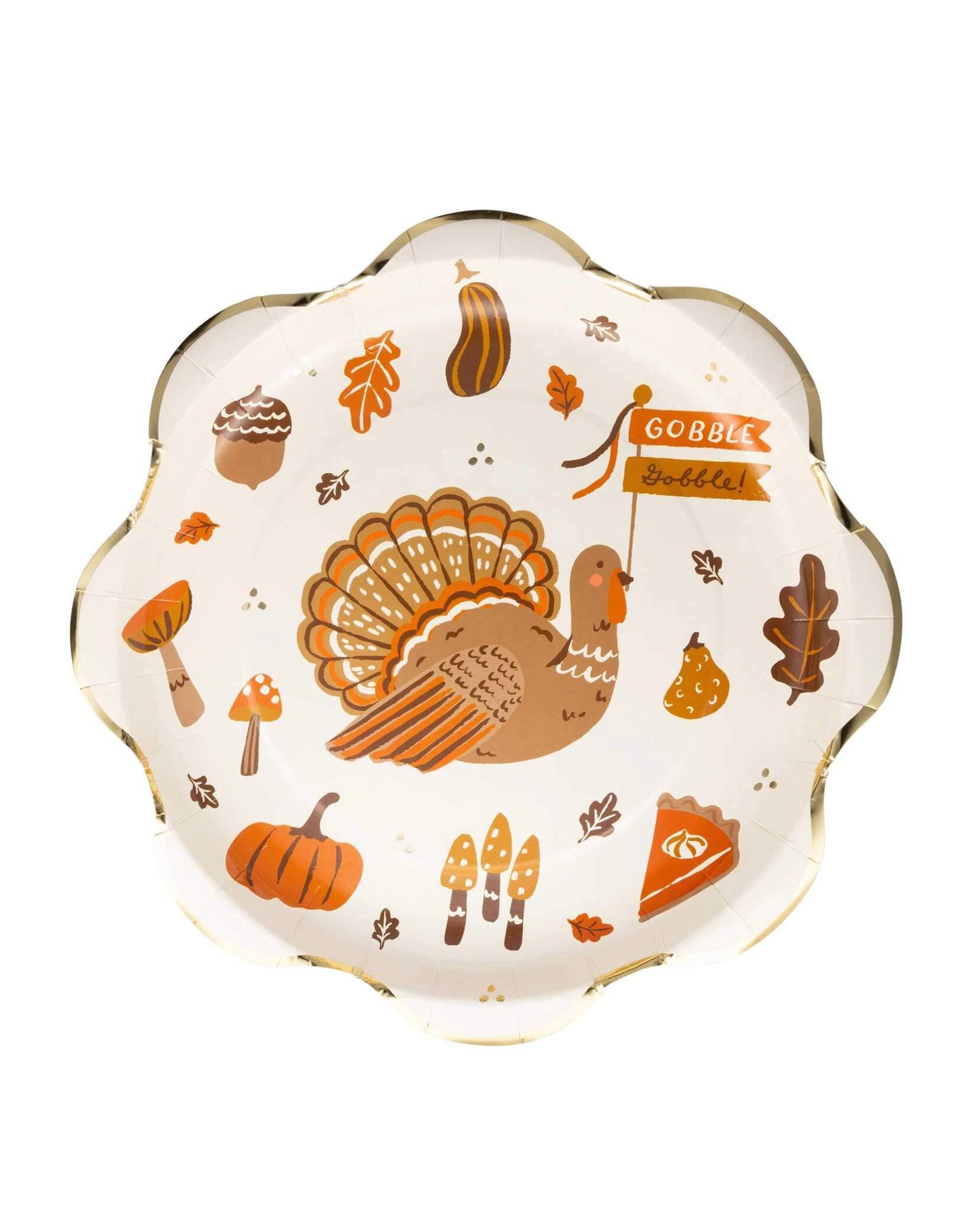 Momo Party's 10" Thanksgiving Icons Plate with decorative Thanksgiving-themed illustrations including turkeys, pumpkins, pumpkin pies, acorns, fall leaves and more with gold foil edge by My Mind's Eye on a white background.