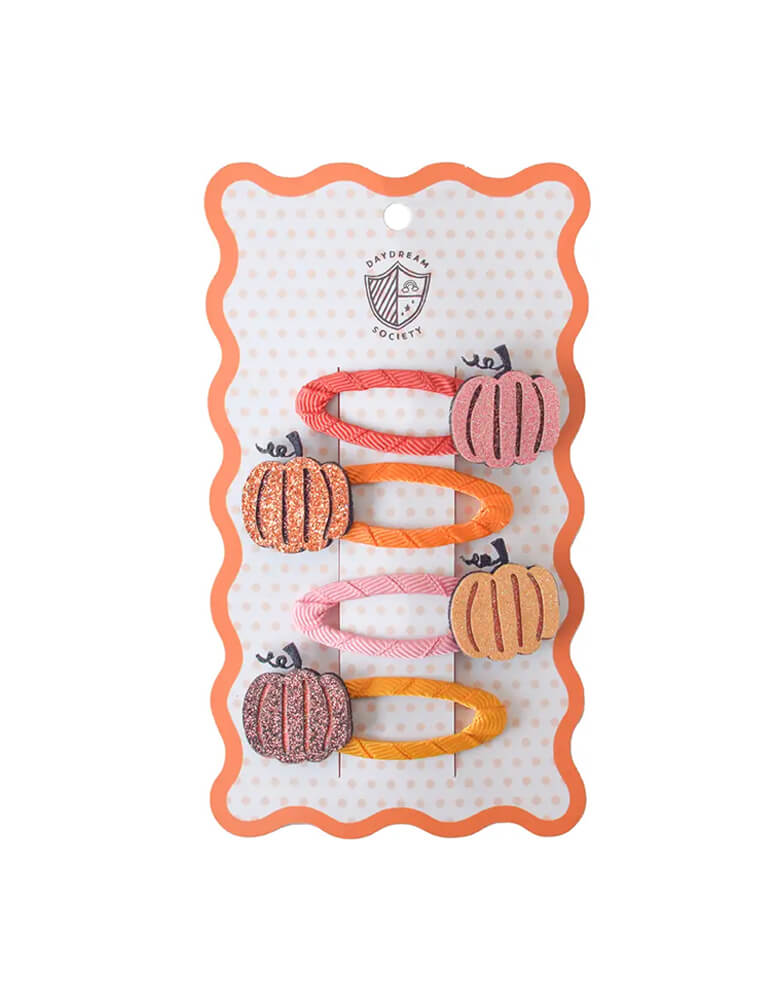 Momo Party's set of pumpkin-shaped hair clips in pink and peach designs on a Daydream Society card with a white background.