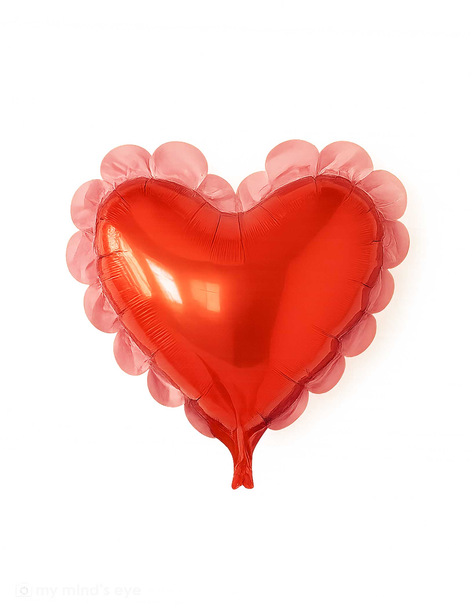 Momo Party's 22" scalloped heart mylar balloon by My Mind's Eye on a white background .Featuring an elegant scalloped edge design, this statement piece brings romance and festive flair to Valentine's Day parties, proposals, and special occasions. The oversized format makes it a stunning focal point for photo backdrops, balloon garlands, or standalone displays. 