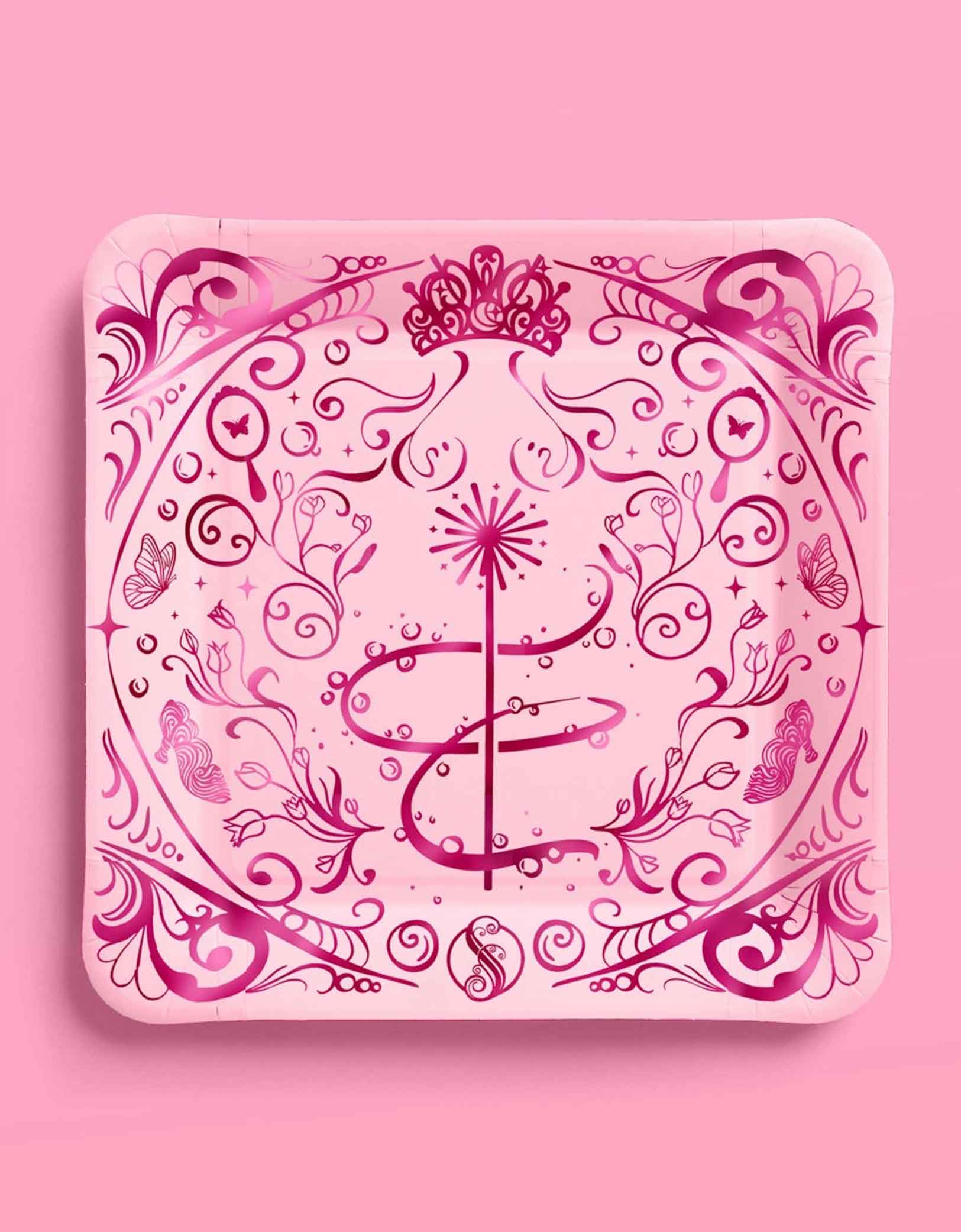 Momo Party's 10.5" Wicked party dinner plates in pink with intricate wizard and Glinda inspired designs on a pink background.