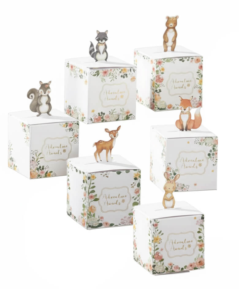 Momo Party Woodland Baby Favor Boxes - Pink by Kate Aspen. This set comes with 6 different animal designs, featuring floral border, "Adventure Awaits" text, and 3D paper animals: raccoon, squirrel, fawn/deer, fox, bear, and bunny. Perfect for baby shower or first birthday party favors.