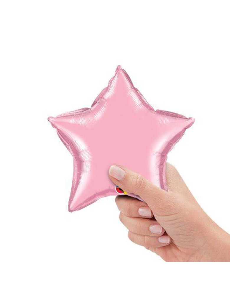 Qualatex Balloons - 9″ Mini Star Shaped Foil Balloon in Pearl Pink color with a hand holding it