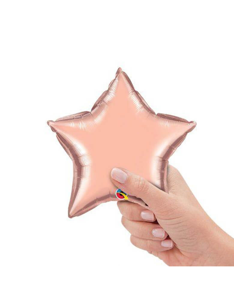 Qualatex Balloons - 9″ Mini Star Shaped Foil Balloon in Pearl Pink color with a hand holding it.