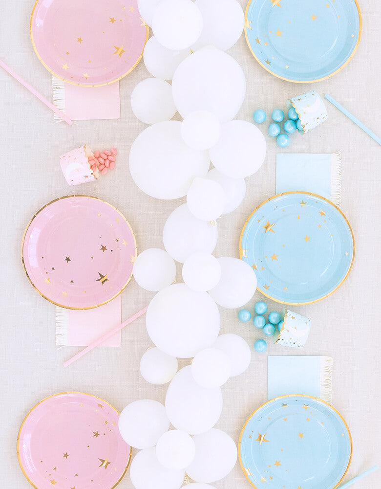 Baby Shower Gender Reveal Party table inspiration with My minds' eye Baby Blue Star Large Plates, Baby Blue Fringe Cocktail Napkins, Baby Blue Food Cups on one side, Baby Pink Star Large Plates, Baby Pink Fringe Cocktail Napkins,Baby Blue Food Cups on another side, white latex balloons as center piece