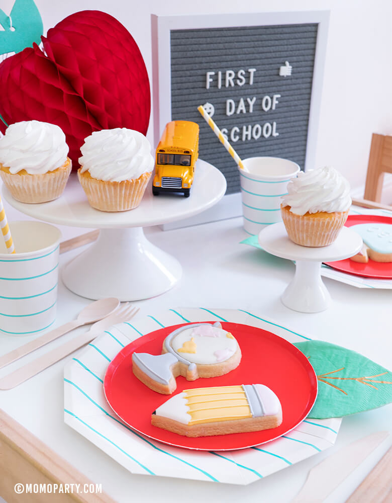 Momo party - Modern Back To School Party Table inspiration with Oh happy day Cherry Red side plate with Meri Meri Leaf napkin represent as Apple. Aqua Striped Large Plates and cups, Leaf Napkins, Letter board with "First Day of School" sign,  , Honeycomb Apple, cupcakes, and school bus toy on cake stand as tableware