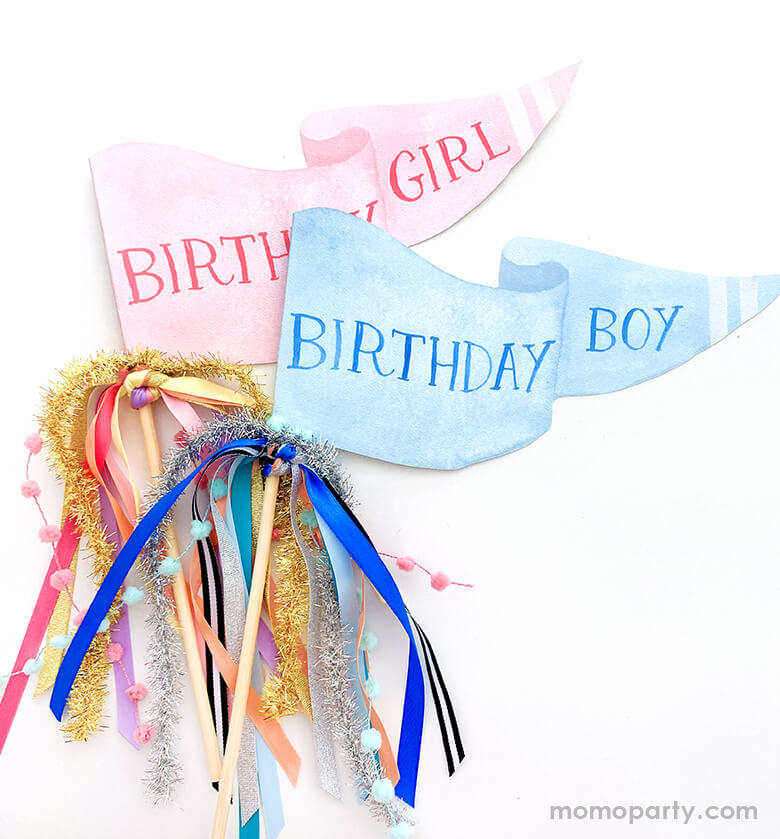 Close up details of Cami Monet - Birthday Girl Party Pennant and Birthday Boy party pennant. These Handmade pennants made in United States of America, in Size: 10 x 5 inches. They are made of 120 lb. luxe watercolor texture paper with handwriting "Birthday Girl" in pink and "Birthday Boy" in blue text in watercolor illustration for extra whimsy. With matched colors and gold mixed Ribbon and sparkle garland. These adorable party pennants are perfect for a Birthday Day celebration!
