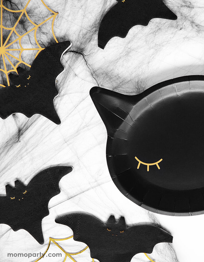Halloween Party table with Party Deco Black Cat Halloween Plates in a cute Cat head die-cut Shape with eyes in a gold foil. and Black Bat napkins,  and Gold Spiderweb Decorations for a kid halloween party