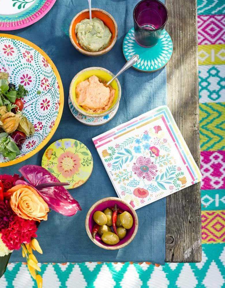 A Boho Fiesta Themed Party Table featuring Talking Tables 9" Boho Fiesta Floral Plates and Napkins with treats and fresh flowers