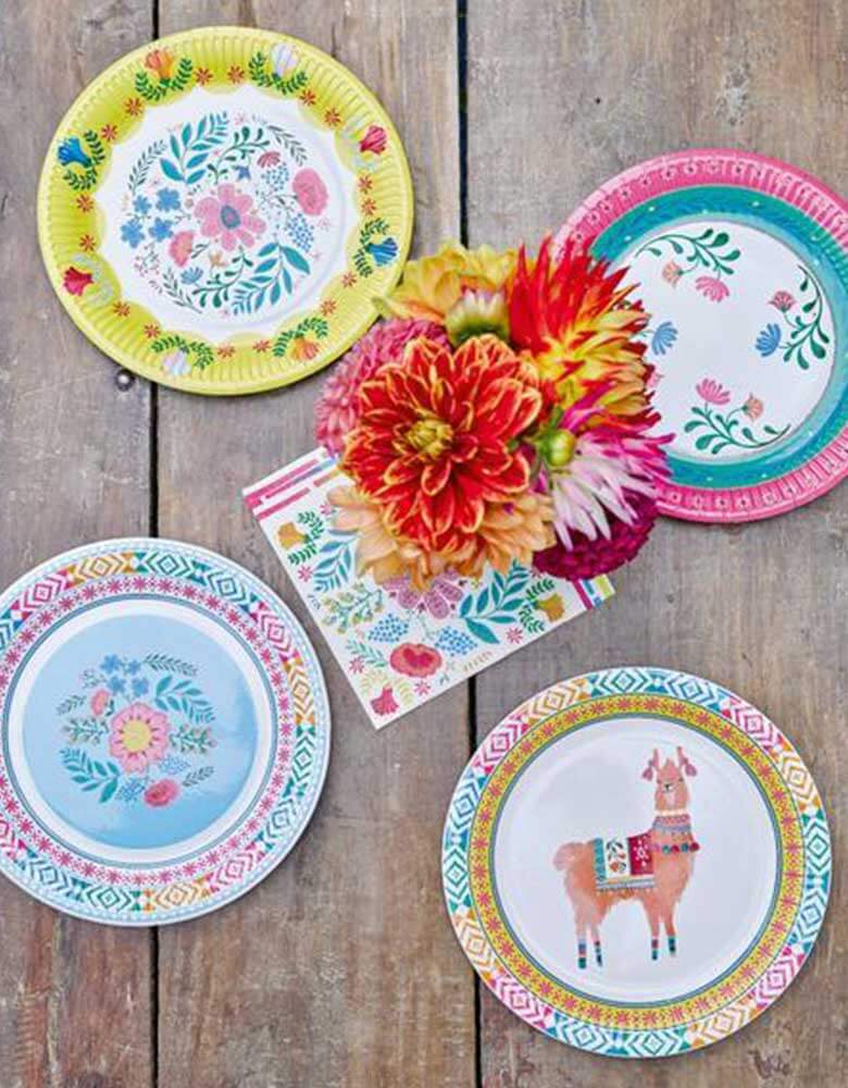 A Boho Fiesta Themed Party Table featuring Talking Tables 9" Boho Fiesta Floral Plates, Llama plates and Floral Napkins with fresh flowers