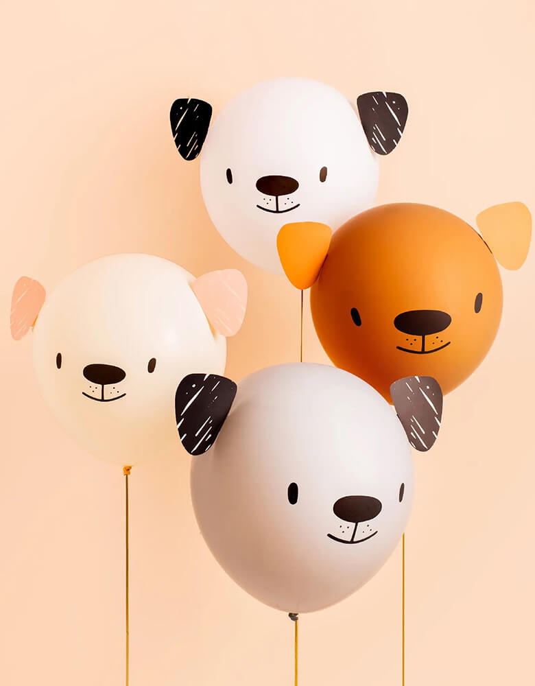 four neutral colored latex balloons printed with dog faces and decorated with dogs hears, they make great balloon decorations for kid's puppy themed birthday party
