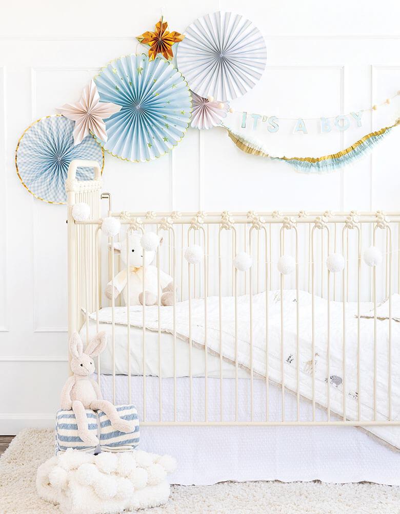 Baby boy's nursery decoration ideas featuring my mind's eye baby blue paper fan and it's a boy banner on the wall