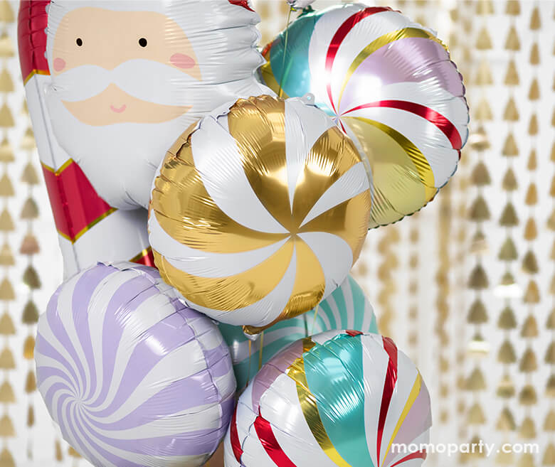 Holiday Foil balloons boutique with Candy Foil Balloon in Mixed Colors, Pastel purple color, Pink color and green color, Red Candy Cane Foil Mylar Balloon and Santa foil balloon. in front of Christmas Tree Gold Backdrop, with lots of bubbles around, Such a fun party decoration for a holiday celebration
