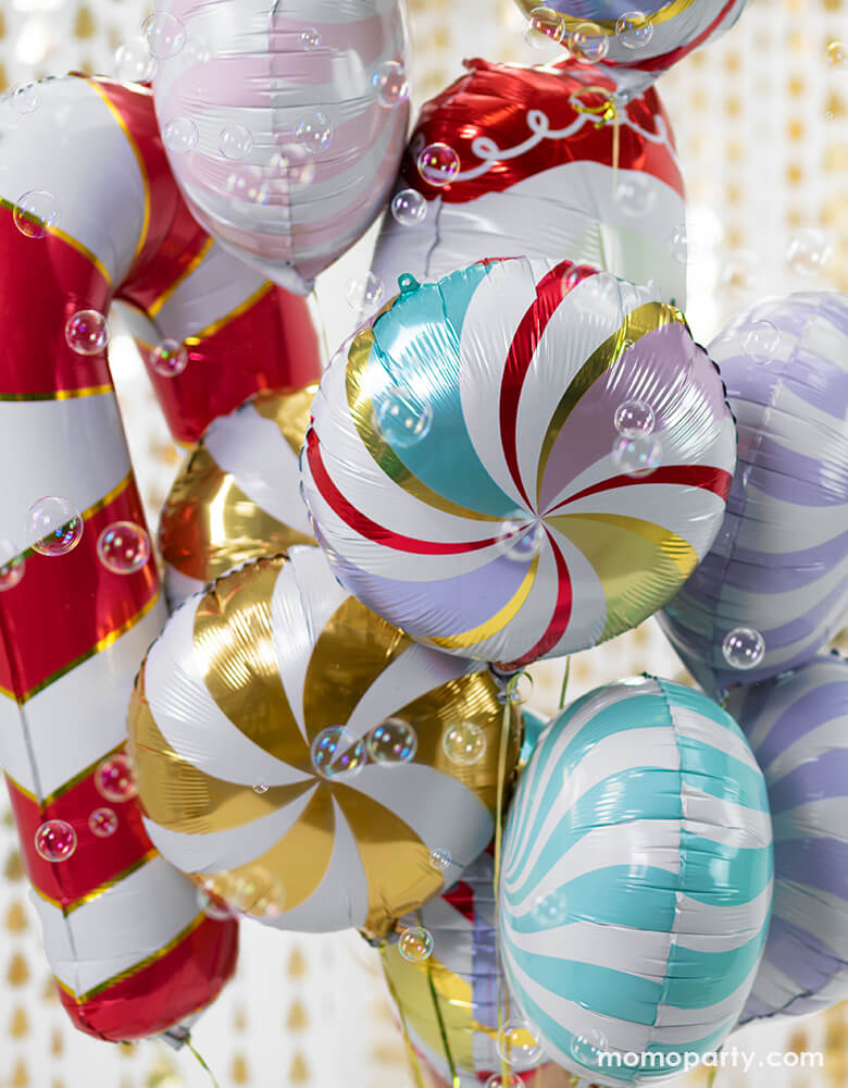 Holiday Foil balloons boutique with Candy Foil Balloon in Mixed Colors, Pastel purple color, Pink color and green color, Red Candy Cane Foil Mylar Balloon in front of Christmas Tree Gold Backdrop and lots of bubble around it, Such a fun party decoration for a holiday celebration