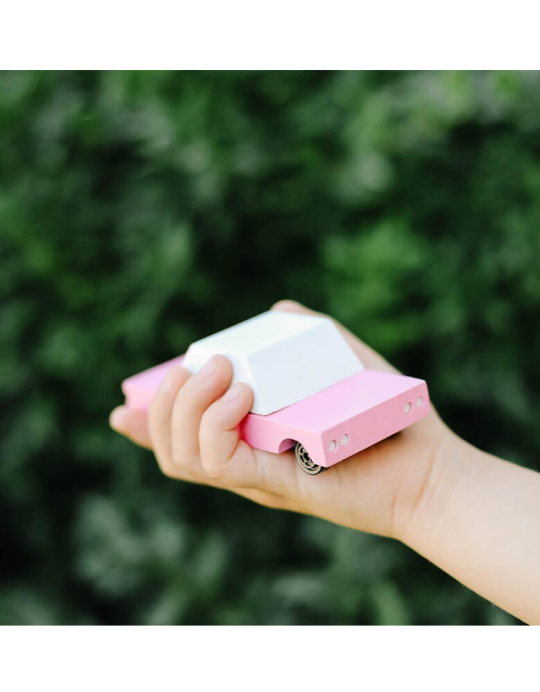 Kid's holding a Candylab Candycar Pink Sedan in a backyard