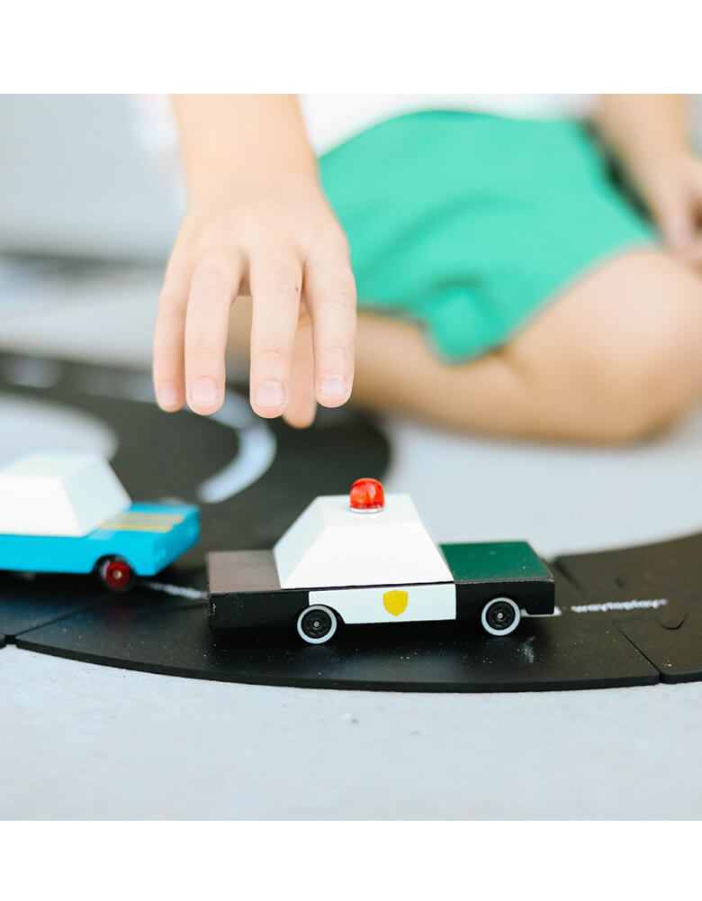 Kid's playing Candylab Candycar Shewiff on a toy asphalt road