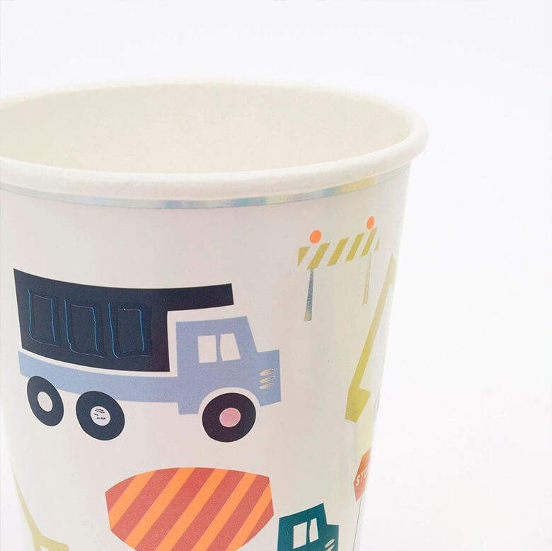 close up details of Meri Meri Construction Party Cups. Featuring graphic morden vehicles design, with lots of sensational silver holographic border and foil details