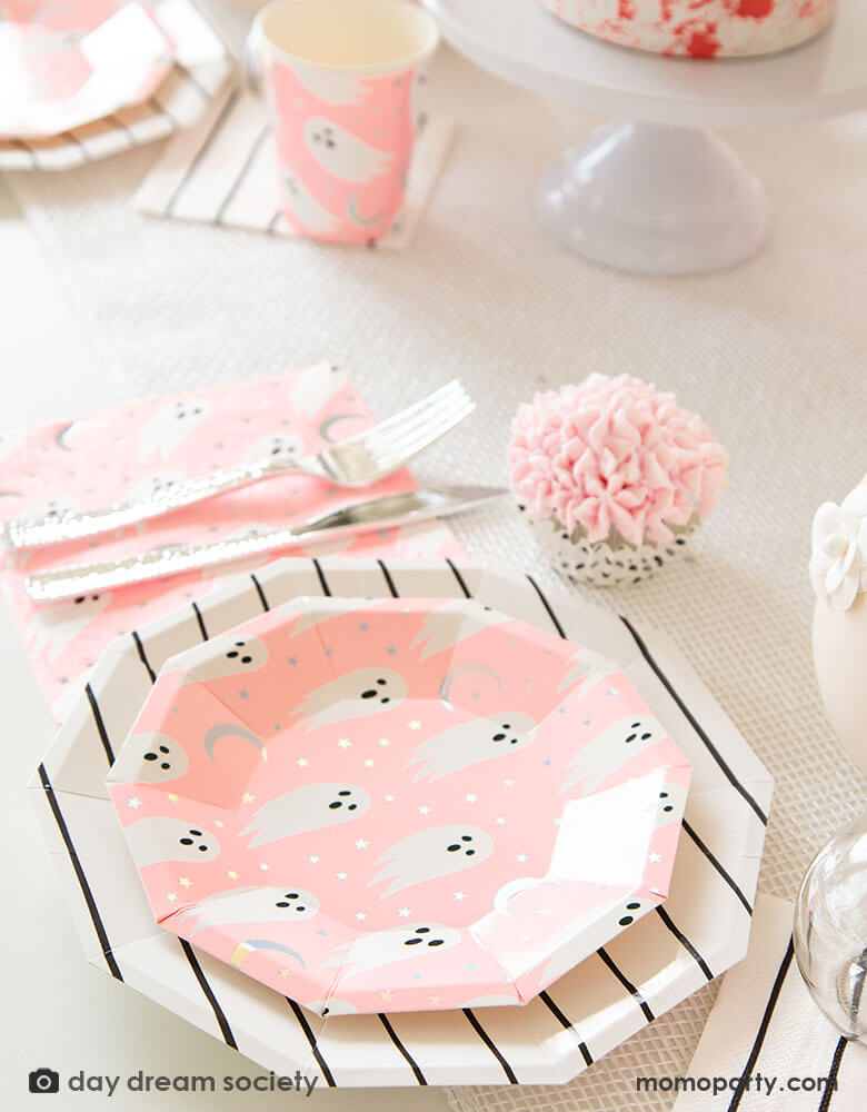 An adorable Kid's halloween party table filled with Daydream Society's Spooked collection featuring ghosts design on a bright neon pink background. Perfect inspiration for a pink Halloween celebration