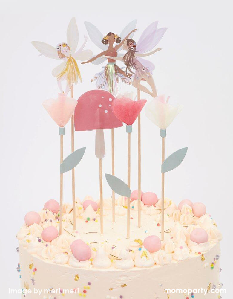 a Beatuful cream butter cake with Meri Meri Fairy Cake Topper. Featuring 3 fairies, a toadstool and flowers topper on top of it