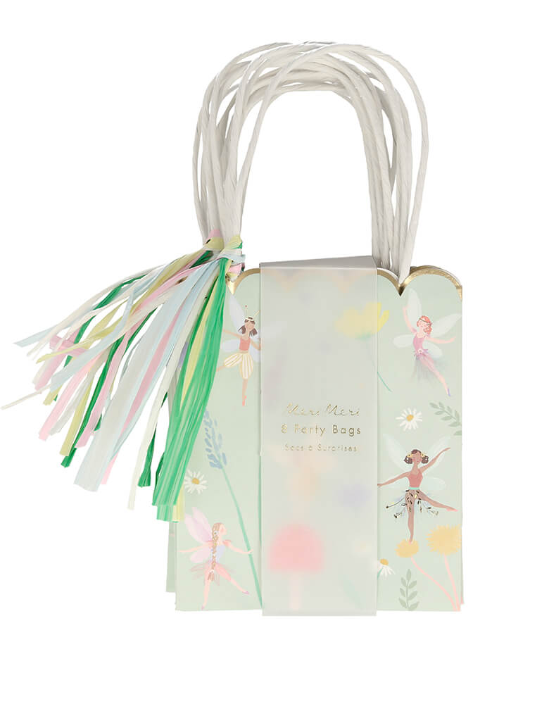 Meri Meri Fairy Party Bags. Set of 8. They are crafted with a stylish scallop edge and feature illustrations of dancing fairies, flowers and toadstools, and golden foil detail. The bags have twisted paper handles and gorgeous raffia tassels.