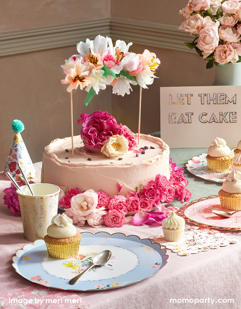 Floral garden tea party with a buttercream cake decorated with roses and Meri Meri Flower Bouquet Cake Topper. With English Garden Dinner Plate set with cupcakes on them for a Modern elegan afternoon tea party, baby shower, bridal shower or any spring birthday party