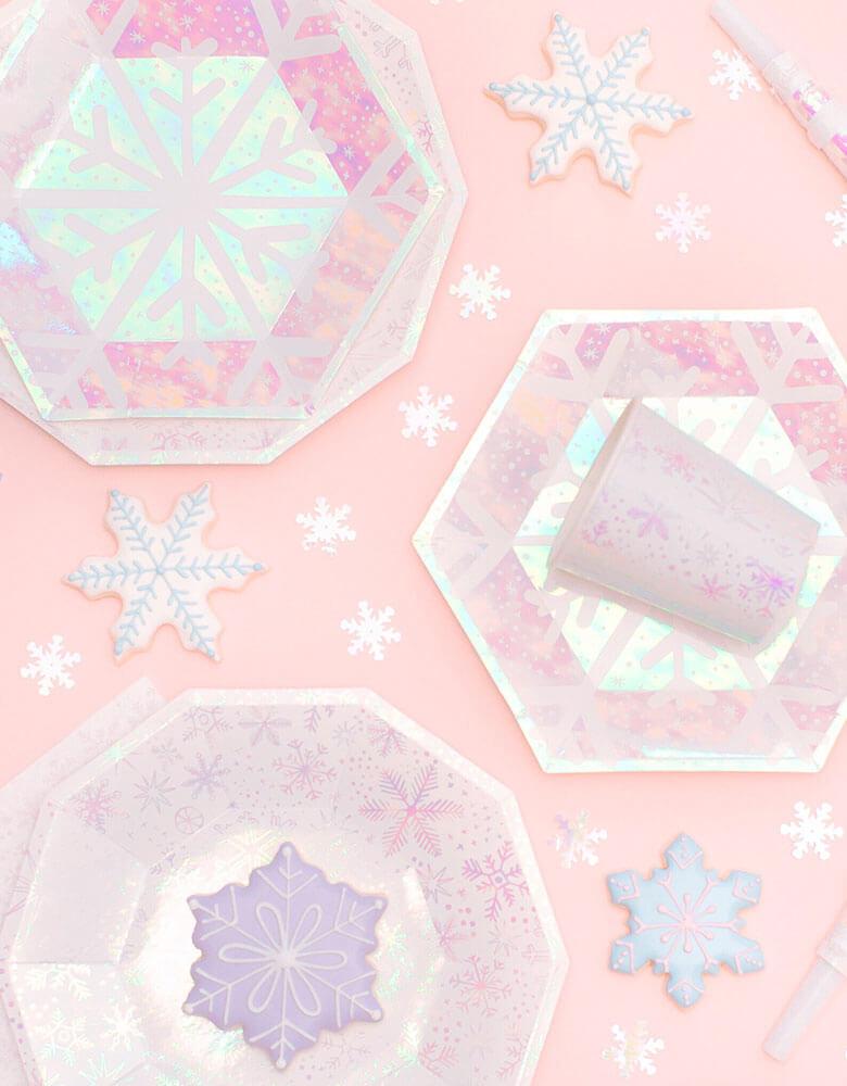 Daydream Society_Frosted Collection_Snowflake Party Goods on a pink background with snowflake cookies on it. Party ware for Winter, Snow, Christmas, Frozen, Frozen 2 Party