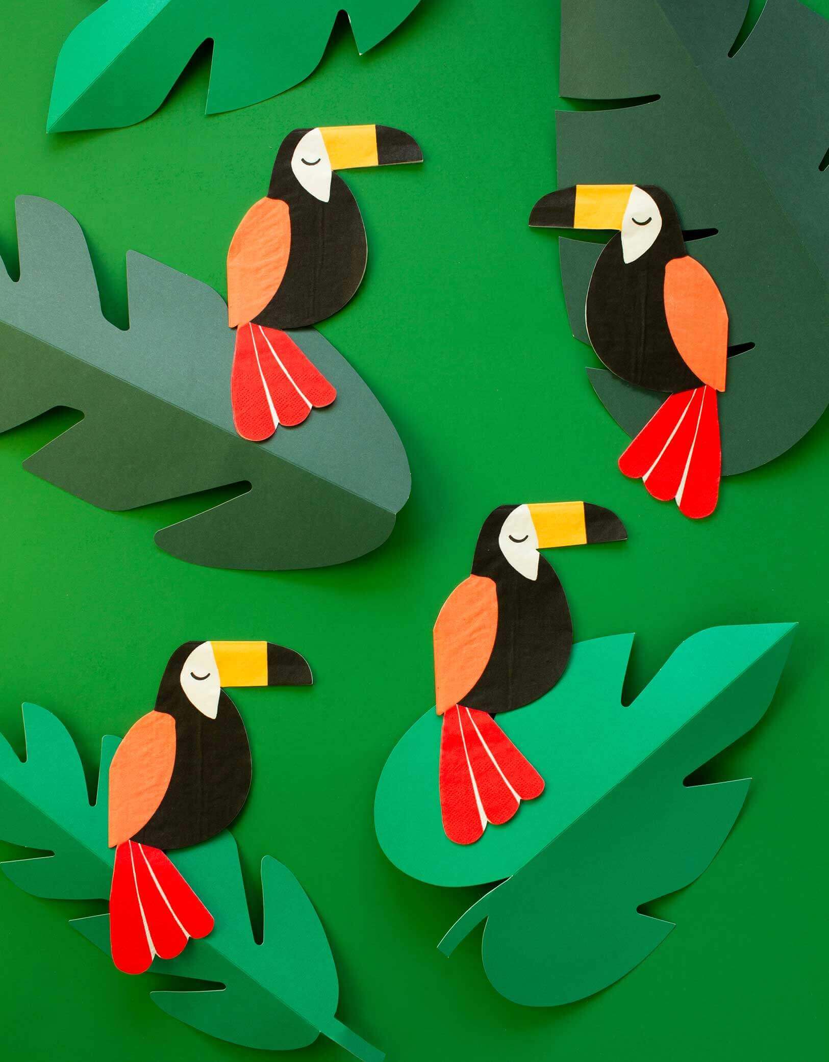 napkins with toucan design on the green leaves