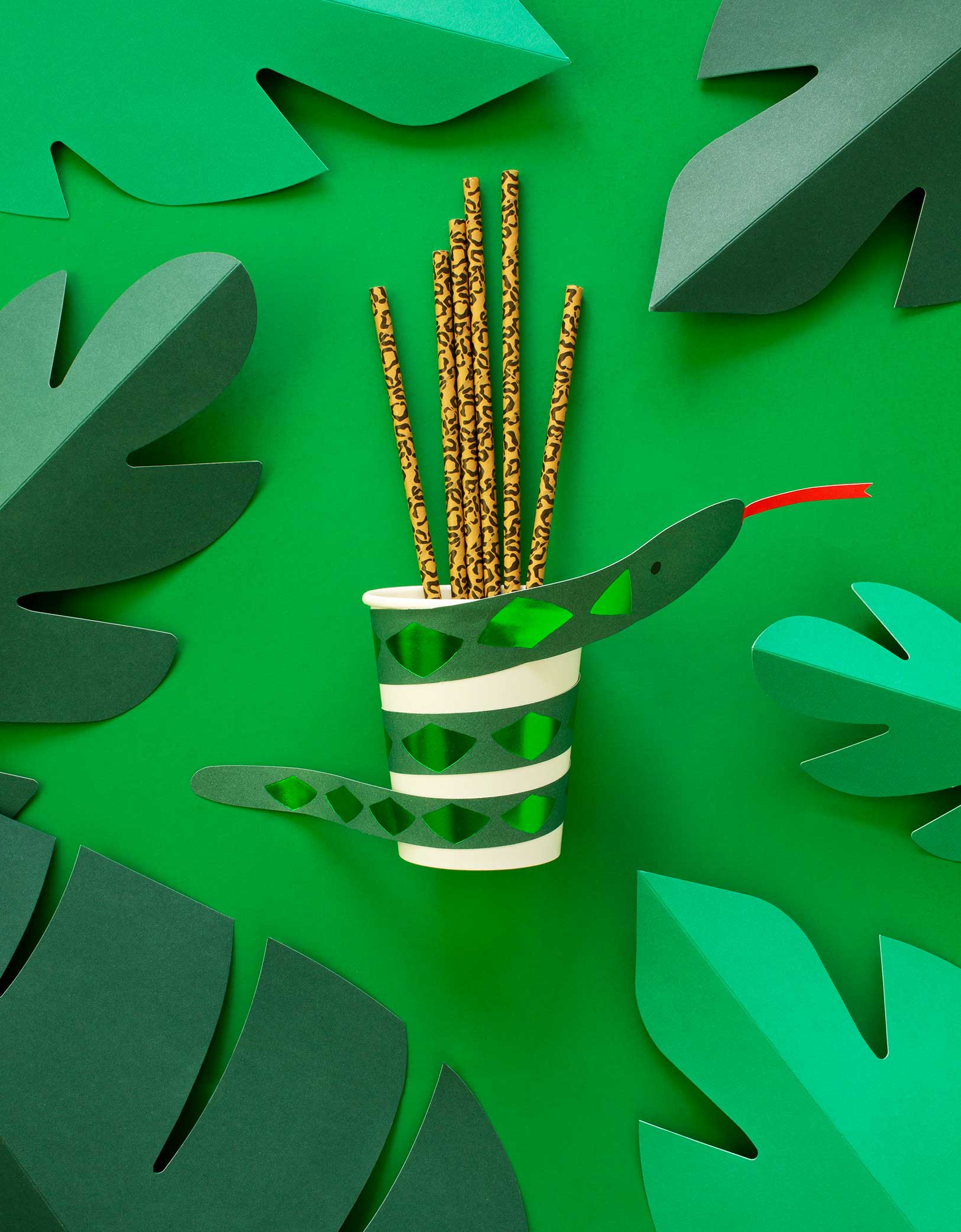 Meri Meri Snake Paper Cup with Animal printed Paper Straw on the green graphic background with paper leaves 