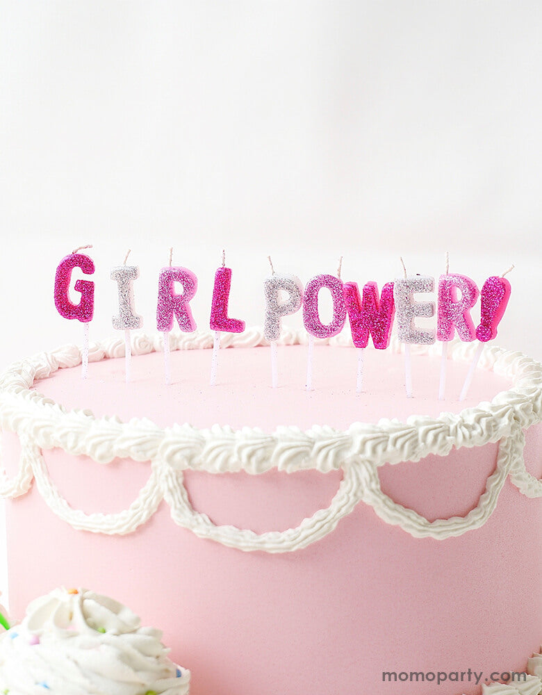 a pastel pink butter cake with Party Partners - Girl Power Candle Set. 