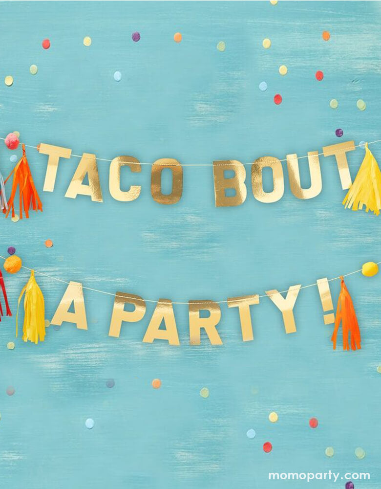 Ginger Ray - Gold Taco Party Pom Pom And Tassel Party Banner. Featuring colorful pompom and tassel around "taco bout a party!" in a gold letter banner. This shiny gold 'Taco Bout A Party' backdrop will bring a fun touch to fiesta celebrations! Get your guests talking with this gold Taco Bout A party banner!