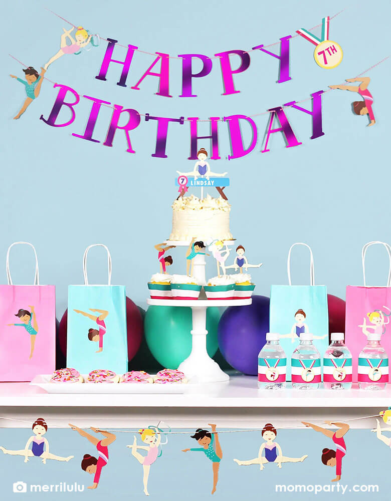 A festive gymnastics themed birthday party decorated with Merrilulu's Happy Birthday banner with cupcakes and cakes on the party table with customized name and age