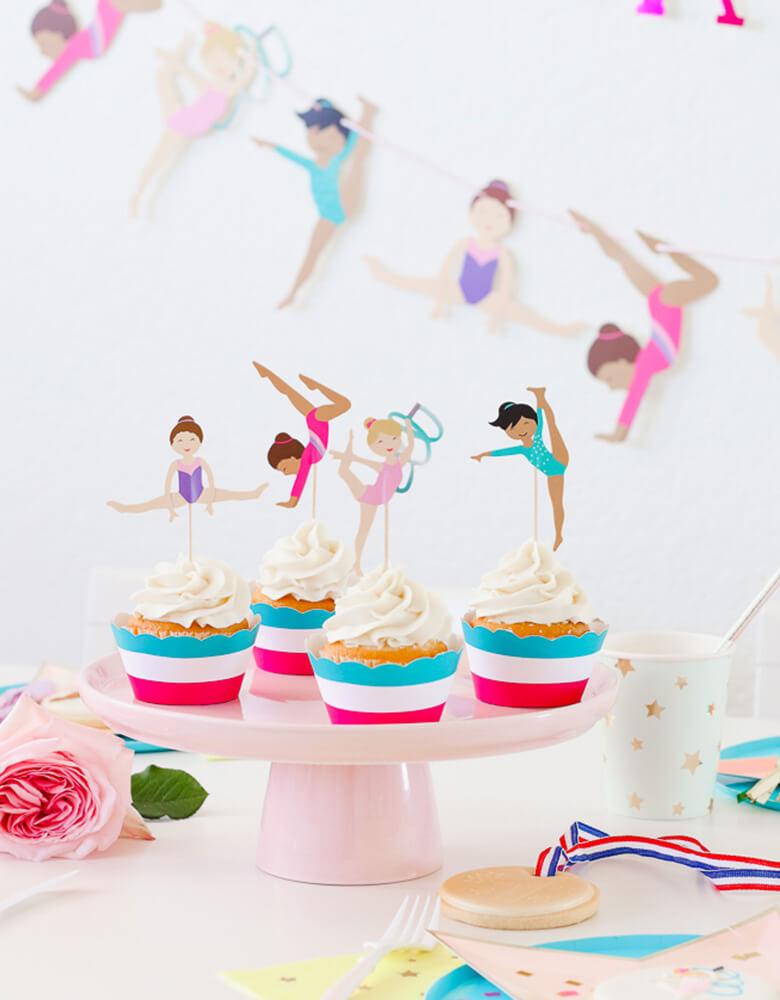 Cupcakes with Gymnastics Themed toppers on a cake stand from a girl Gymnastics Party styled by Twinkle Twinkle Little Party