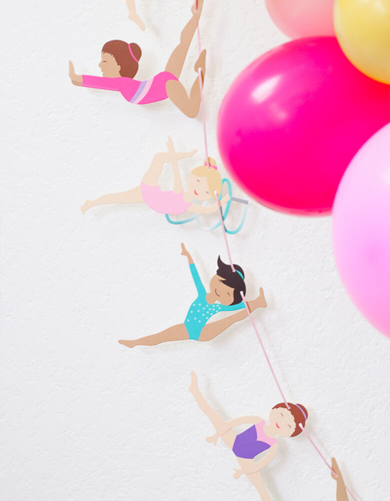 Gymnastics Garland next to a colorful balloon garland in a Gymnastics Themed Birthday Party styled by Twinkle Twinkle Little Party