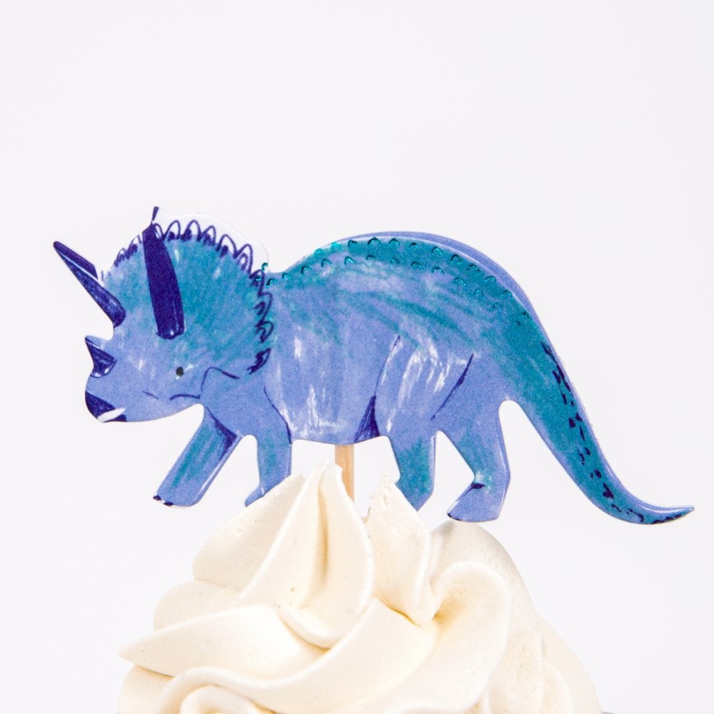 Close up details a cupcake decorated with Blue Triceratops cupcake topper from Meri Meri Dinosaur Kingdom Cupcake Kit