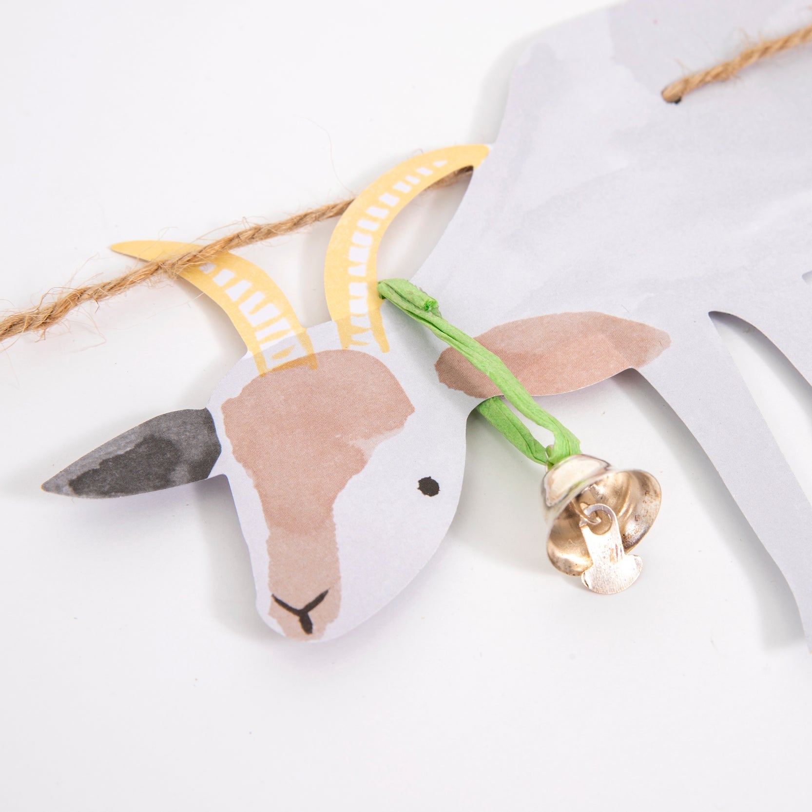 Detail look of Meri Meri On The Farm Large Garland. With bell on a Beautifully illustrated and crafted Goat pennant. This high quality and designed party garland is so fun for kids farm themed birthday party, decoration in their room.