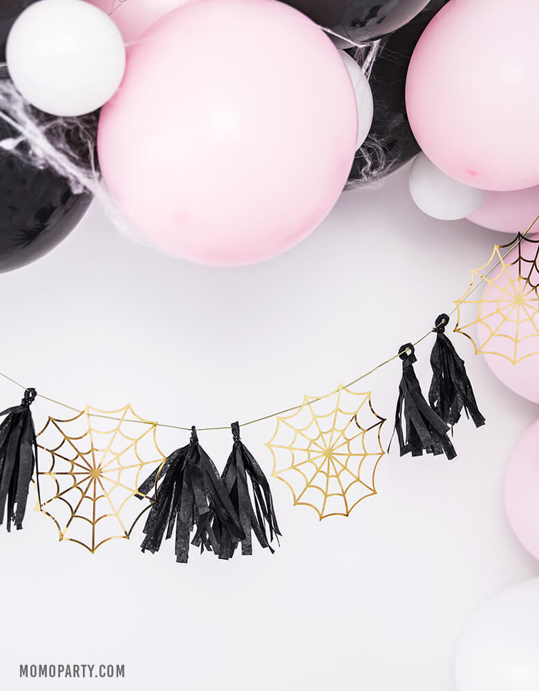 Pastel Pink halloween party decoration with Pastel pink and black balloon garland, Party Deco Halloween Spider web Paper Garland of boo-tiful gold spiderwebs and black tassels. for halloween home decoration, Kids modern spooky halloween party, hocus pocus party trick-or-treating party, nightmare before christmas party, witch themed party and all halloween related celebrations