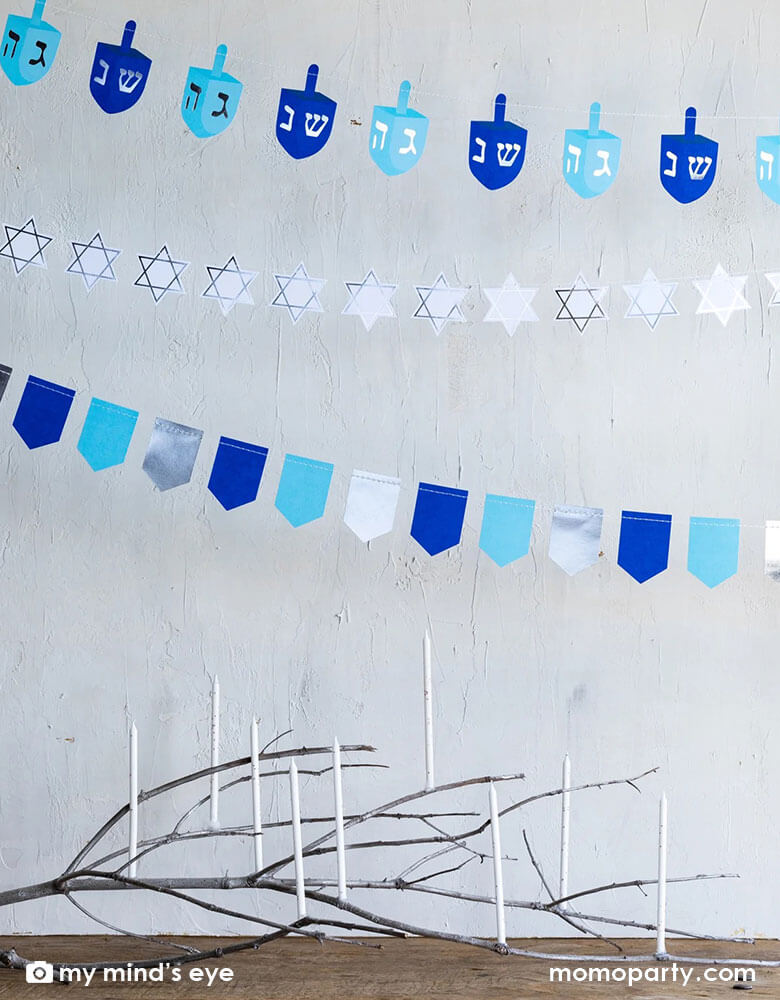 A beautiful modern wooden table with 9 candles celebrating Hanukkah featuring Momo Party's 5' Hanukkah mini banner set on the wall, setting a perfect scene for a Hanukkah celebration.
