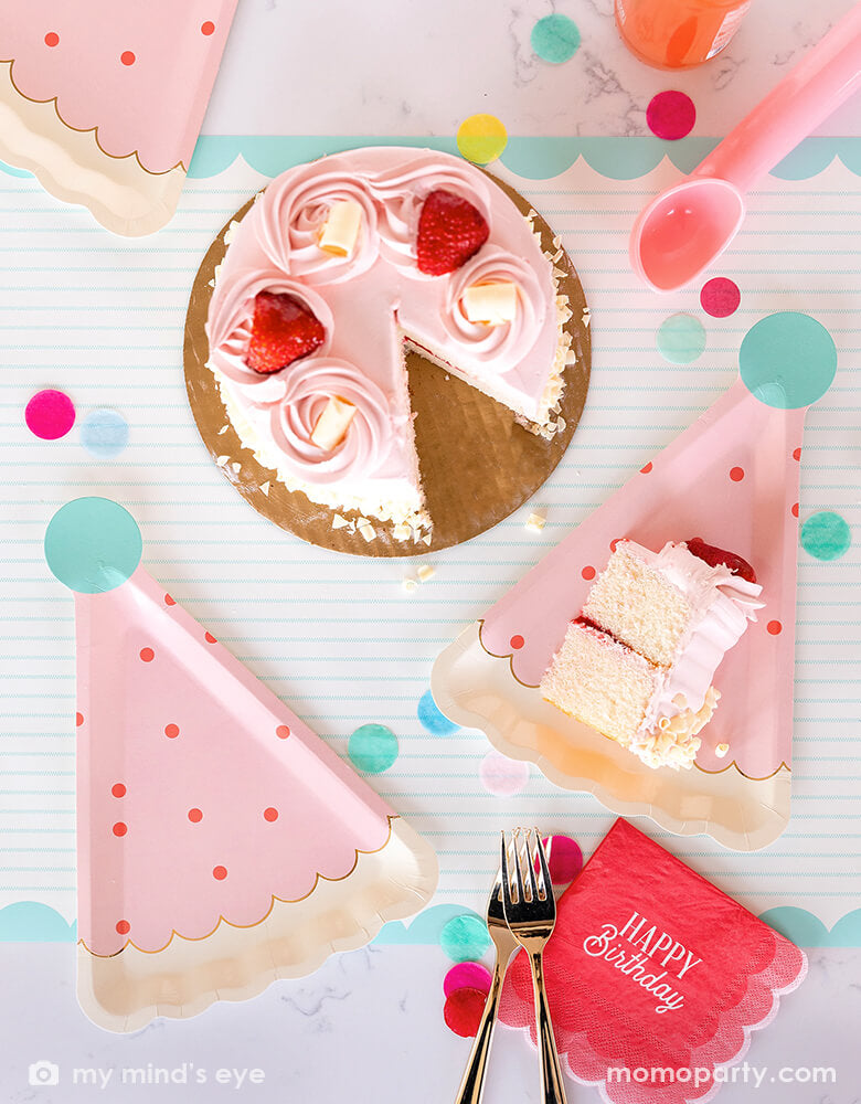 A darling birthday party table with a pink strawberry buttercream birthday cake, filled with cheerful confetti in mint, coral and yellow and My Mind's Eye coral scalloped Happy Birthday napkins with pink birthday hat shaped party plates - a perfect size for serving birthday cakes - all makes a great modern and simple inspiration for a girl's birthday celebration. 