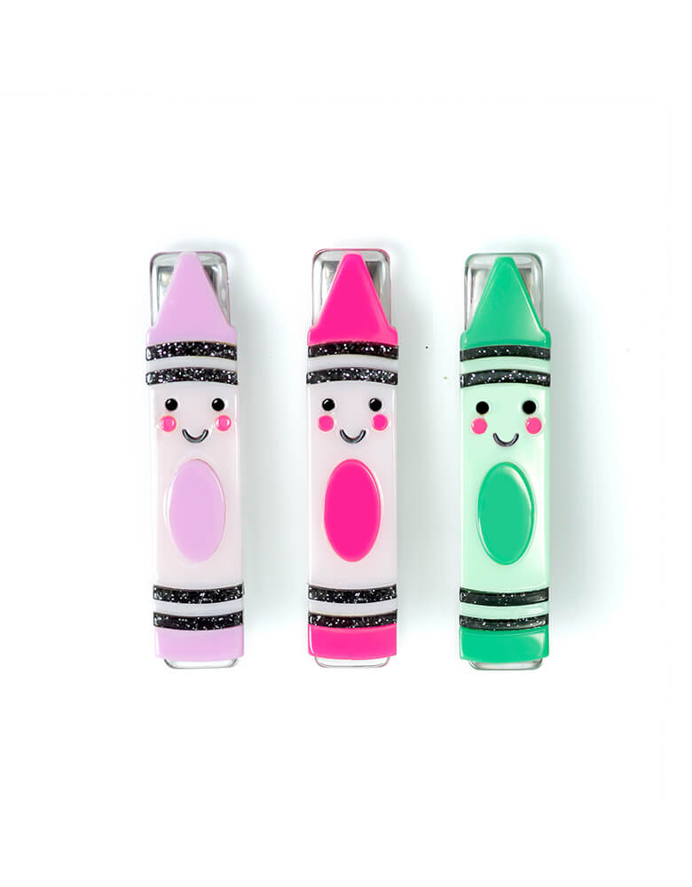 Happy Crayons Pastel Alligator Clips by Lilies & Roses. This trio crayon clip set featuring crayon shaped design with happy face and comes in pastel pink, green, and purple colors, Its the perfect back-to-school accessory for your little one