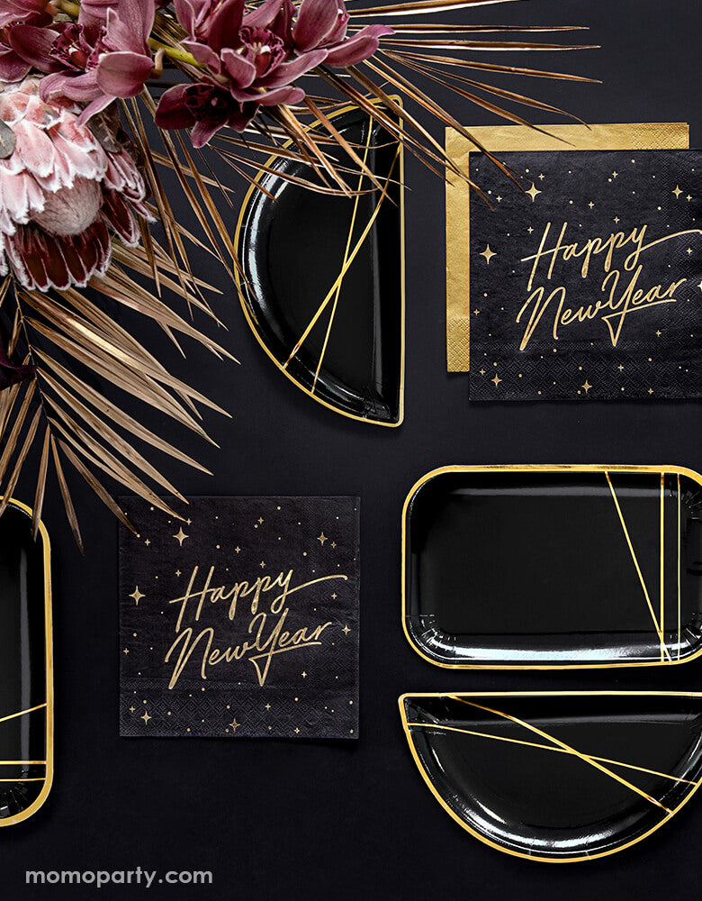 Black and gold new year party table set up with Party Deco - Happy New Year Large Napkins layered with gold napkin, black and gold foil special shaped party plates, Floral as centerpiece in a black table top. Ring in the New Year in style with this gorgeous Happy New Year party collection with gold foil detail. This black and gold new year collection is the perfect party tableware for a new year party! 