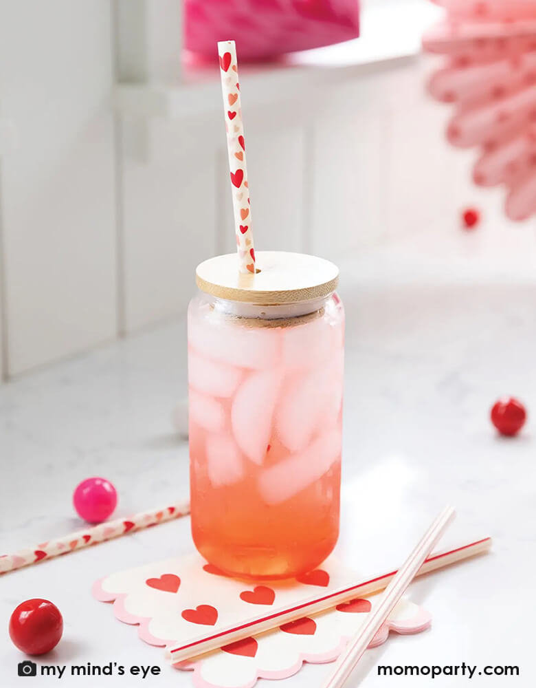 heart shaped straw and giant cocktail glass/Giant cocktail Glass with 2  heart-shaped straws and black background Concept of Valentine's day drink.  Stock Photo