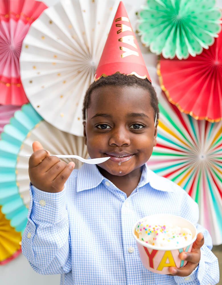 Boy wear Hip Hip Hooray Colorful Party Hats eating ice cream
