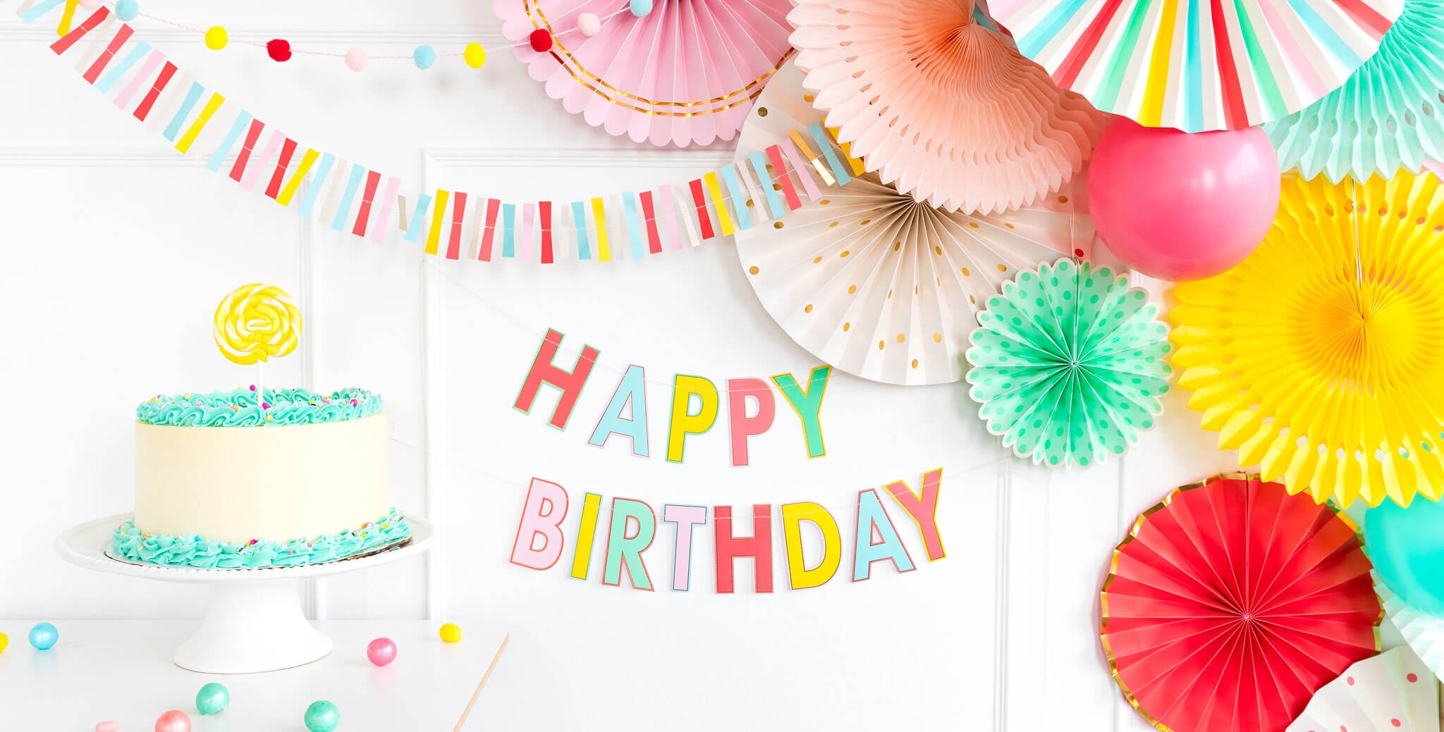 colorful letter happy birthday banner with backdrop paper fans