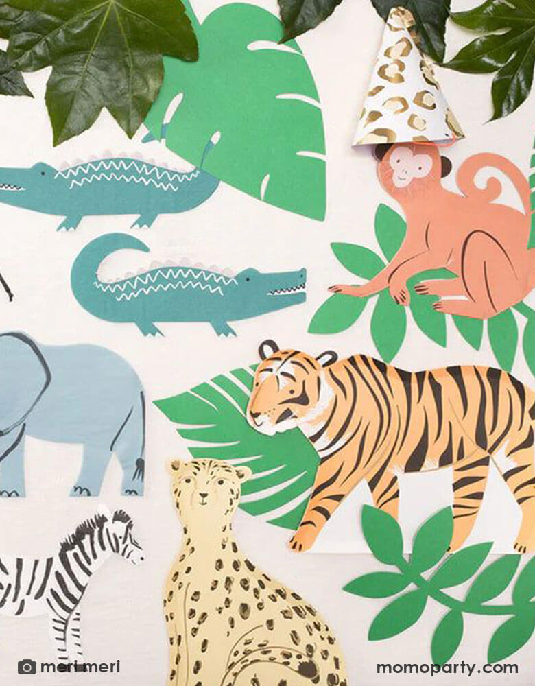 A jungle collage scene made with Momo Party's safari jungle themed tableware including a 11.375 x 7.5" tiger shaped plate, a monkey shaped napkin, two alligator shaped napkins, a cheetah shaped plate, an elephant shaped napkin, and a zebra shaped napkin, along with some palm leaf paper cut decorations, it makes a great inspiration for kid's animal themed party, a "Wild One" 1st birthday party or a "Two Wild" themed second birthday party.