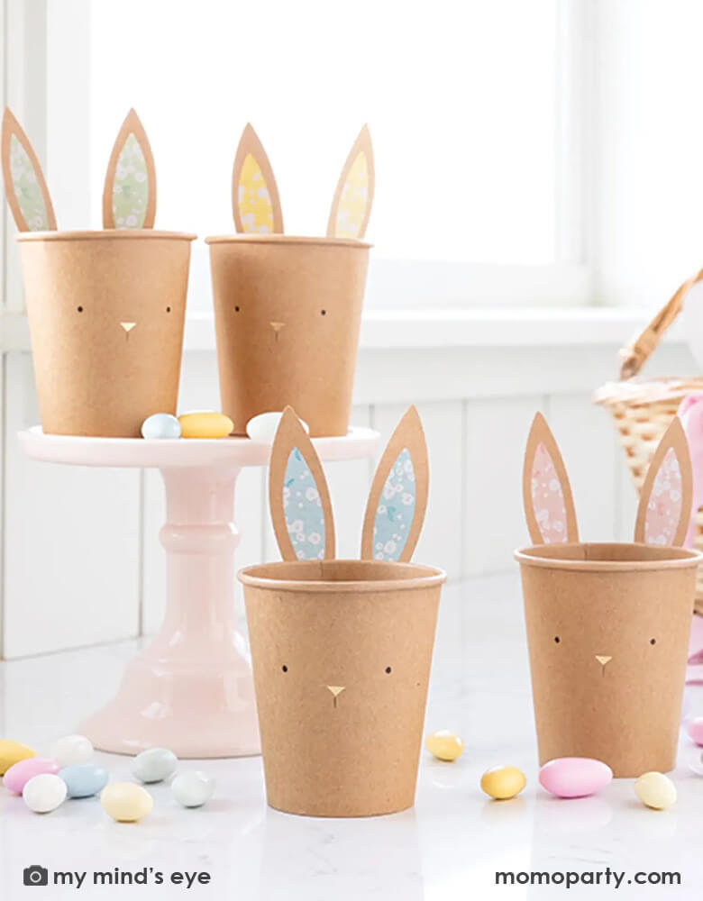 Momo Party's 8 oz kraft bunny cups by My Mind's Eye, come in a set of 8 cups in 4 designs & colors, designed with rustic kraft paper and sweet bunny faces with gold foil accents, these party cups are the perfect addition to your Easter table. Included are attachable ears to make a memorable statement at your table this Easter!