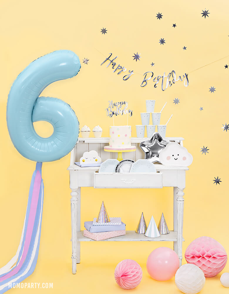 Party Deco - 34 inch - Large Number 6 Pastel Blue Foil Mylar Balloon with pastel blue and pink tissue strings floating on the side of table with cloud shape plates, silver star plates and cake with silver "happy birthday" sign cake topper for a 6 years old birthday 